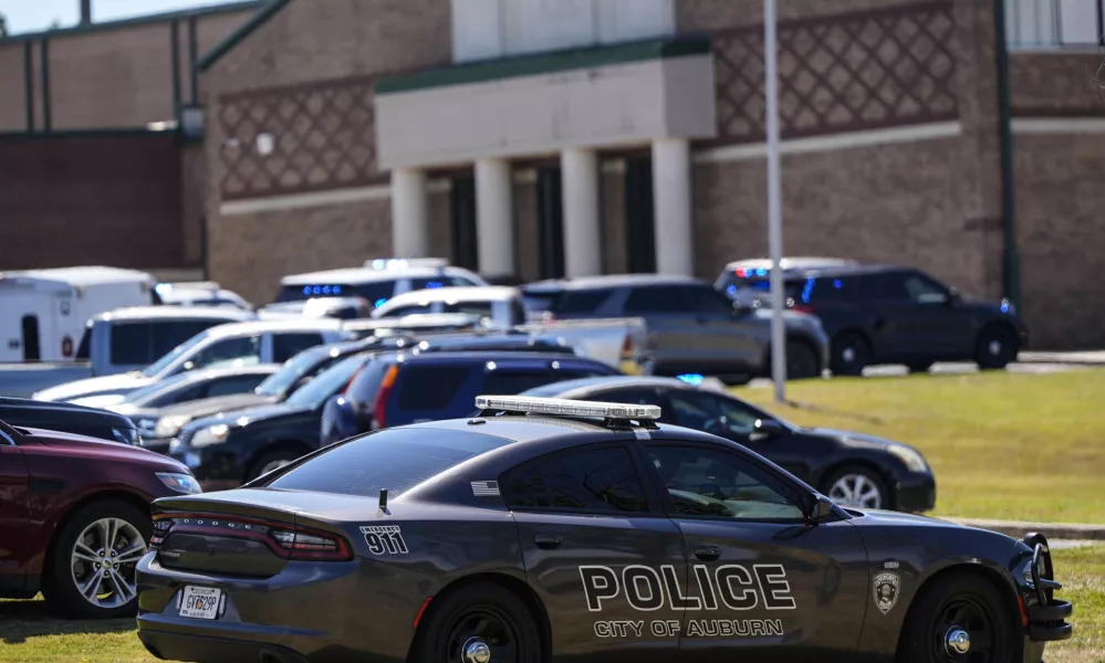 Police vehicles are seen outside Apalachee High School after a shooting there caused an unknown number of injuries and a suspect was arrested Wednesday, Sept. 4, 2024, in Winder, Ga. (AP Photo/Mike Stewart)