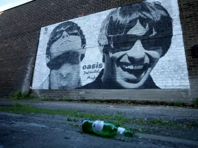 FILE PHOTO: A view of a mural of Oasis band members Liam and Noel Gallagher by artist Pic.One.Art on the side of Sifters record shop in the Burnage area of Manchester, Britain, August 31, 2024. REUTERS/Phil Noble/File Photo