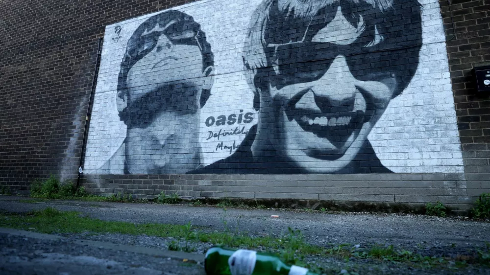 FILE PHOTO: A view of a mural of Oasis band members Liam and Noel Gallagher by artist Pic.One.Art on the side of Sifters record shop in the Burnage area of Manchester, Britain, August 31, 2024. REUTERS/Phil Noble/File Photo