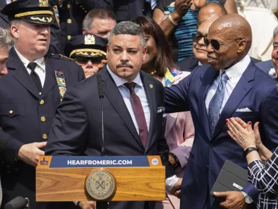 FILE - Edward A. Caban, center, speaks after being sworn in as NYPD police commissioner outside New York City Police Department 40th Precinct on Monday, July 17, 2023, in New York. Mayor Eric Adams on the right. (AP Photo/Jeenah Moon, File)