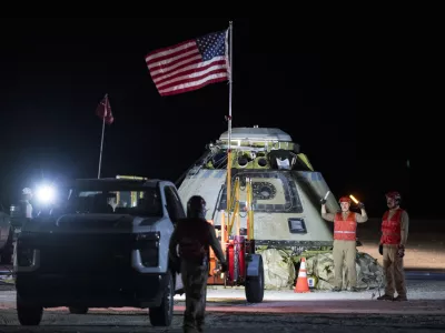 In this photo provided by NASA, Boeing and NASA teams work around NASA's Boeing Crew Flight Test Starliner spacecraft after it landed uncrewed, Friday, Sept. 6, 2024, at White Sands, New Mexico, after undocking from the International Space Station. (Aubrey Gemignani/NASA via AP)