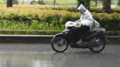 A man rides a motorcycle in the rain caused by typhoon Yagi in Hanoi, Vietnam Saturday, Sept. 7, 2024. (AP Photo/Hau Dinh)