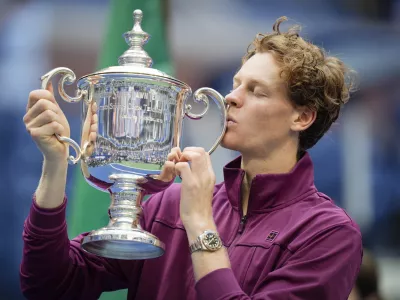 Jannik Sinner, of Italy, kisses the championship trophy after defeating Taylor Fritz, of the United States, in the men's singles final of the U.S. Open tennis championships, Sunday, Sept. 8, 2024, in New York. (AP Photo/Seth Wenig)