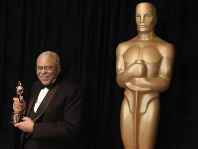 FILE - James Earl Jones poses with his honorary Oscar at the 84th Academy Awards on Sunday, Feb. 26, 2012, in the Hollywood section of Los Angeles. Jones, who overcame racial prejudice and a severe stutter to become a celebrated icon of stage and screen has died at age 93, Monday, Sept. 9, 2024. (AP Photo/Chris Carlson, File)