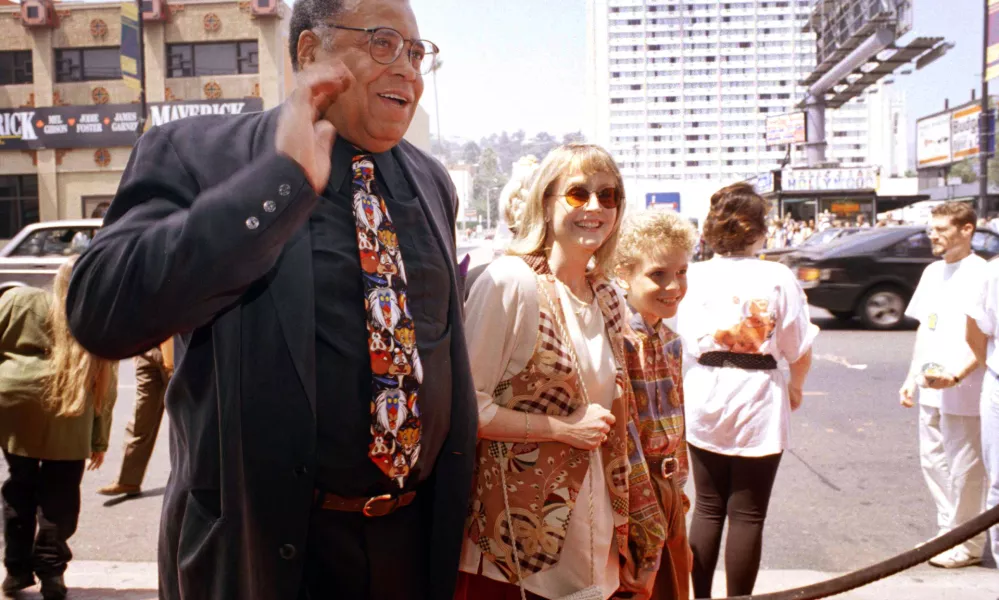 FILE - James Earl Jones, left, greets the press along with his wife Cecilia, center, and son Flynn, right, at the premiere of "The Lion King" in Los Angeles, June 12, 1994. Jones, who overcame racial prejudice and a severe stutter to become a celebrated icon of stage and screen has died at age 93, Monday, Sept. 9, 2024. (AP Photo/Tara Farrell, File)