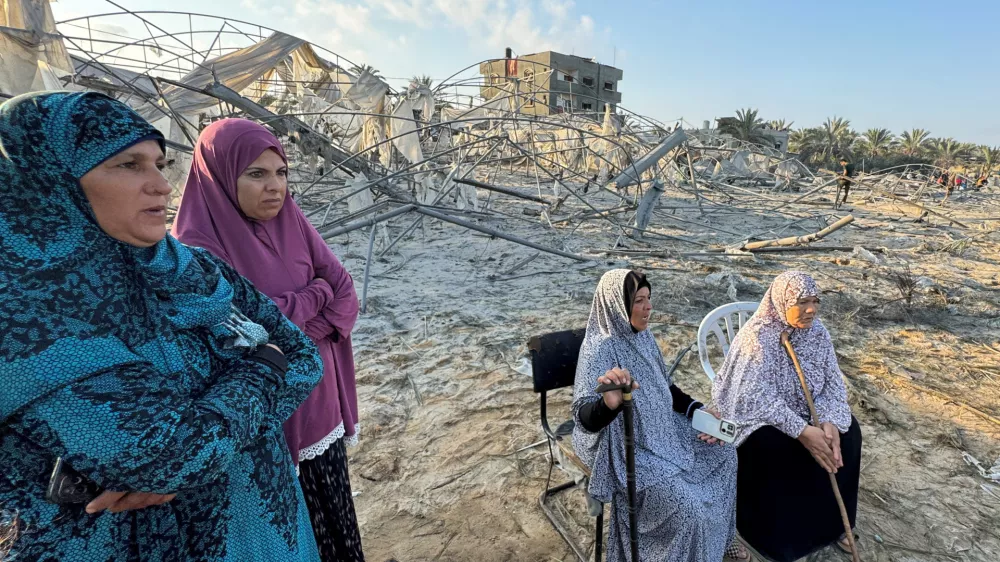 Palestinian women look on at the site following Israeli strikes on a tent camp sheltering displaced people, amid the Israel-Hamas conflict, at the Al-Mawasi area in Khan Younis, in the southern Gaza Strip, September 10, 2024. REUTERS/Mohammed Salem   TPX IMAGES OF THE DAY