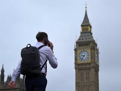 FILE PHOTO: A man walks with his phone on Westminster Bridge towards Big Ben in Westminster, London, Britain, September 2, 2024. REUTERS/Jaimi Joy/File Photo