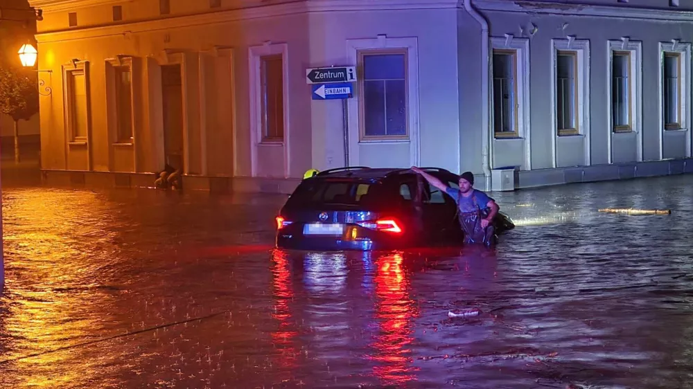 14 September 2024, Austria, Zwettl: A man leans on a car submerged in flood water. Due to heavy rainfall, the whole of Lower Austria was declared a disaster area on 15 September. Photo: Doku-Nö/APA/dpa