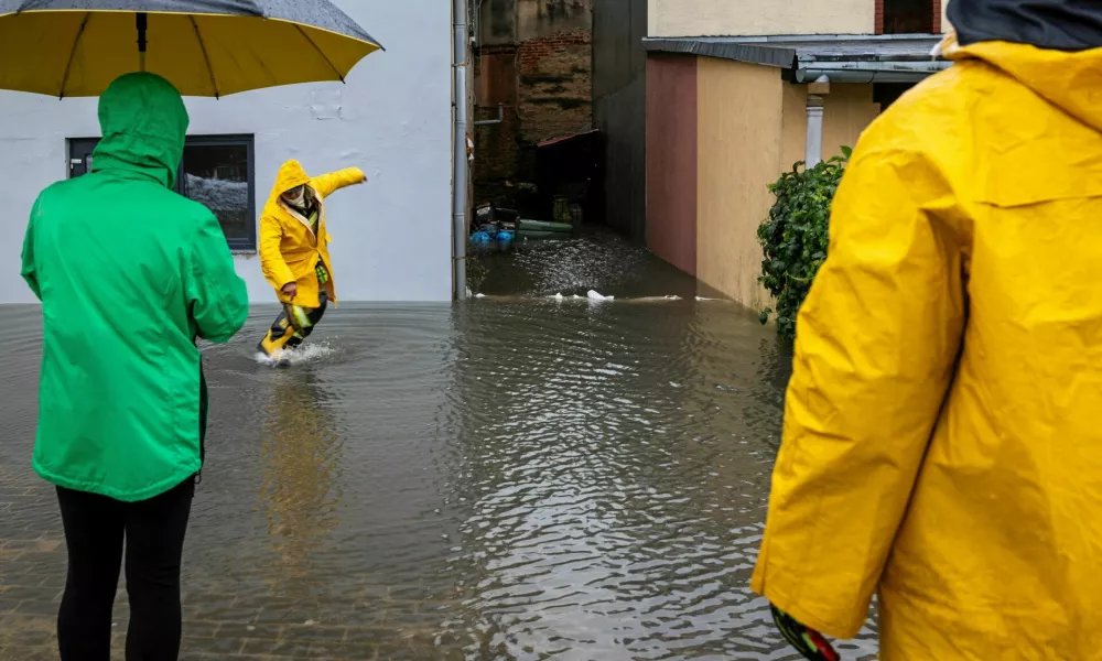 People stand on a flooded street following heavy rainfalls in Glucholazy, Poland, September 14, 2024. Grzegorz Celejewski / Agencja Wyborcza.pl via REUTERS ATTENTION EDITORS - THIS IMAGE WAS PROVIDED BY A THIRD PARTY. POLAND OUT. NO COMMERCIAL OR EDITORIAL SALES IN POLAND.