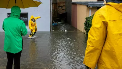 People stand on a flooded street following heavy rainfalls in Glucholazy, Poland, September 14, 2024. Grzegorz Celejewski / Agencja Wyborcza.pl via REUTERS ATTENTION EDITORS - THIS IMAGE WAS PROVIDED BY A THIRD PARTY. POLAND OUT. NO COMMERCIAL OR EDITORIAL SALES IN POLAND.