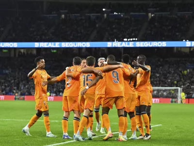 Real Madrid's Kylian Mbappe, centre right, celebrates with team mates after scoring his side's second goal from a penalty kick during a Spanish La Liga soccer match between Real Sociedad and Real Madrid at the Reale Arena in San Sebastian, Spain, Saturday, Sept. 14, 2024. (AP Photo/Miguel Oses)