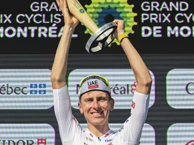 Tadej Pogacar, from Slovenia, raises his trophy after winning the Montreal Grand Prix cycling race in Montreal, Sunday, Sept. 15, 2024. (Graham Hughes/The Canadian Press via AP)