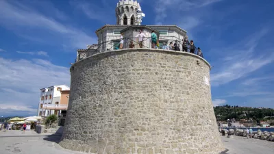 Our Lady of Health Church, Piran / Slovenia - June 24, 2018: Peninsula Piran coastline with church and tourists enjoying sunny day