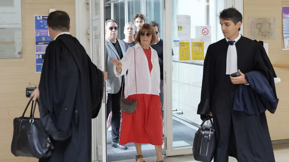 FILE - Gisele Pelicot, left, arrives in the Avignon court house, in Avignon, southern France, Thursday, Sept. 5, 2024. (AP Photo/Lewis Joly, File)