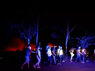 People watching a wildfire make room for emergency vehicles in the vicinity of Soutelo, Portugal, September 17, 2024. REUTERS/Susana Vera