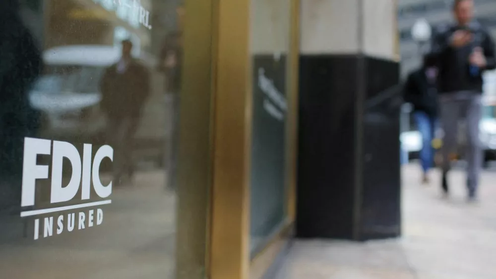 FILE PHOTO: A sign reads "FDIC Insured" on the door of a branch of First Republic Bank in Boston, Massachusetts, U.S., March 13, 2023.   REUTERS/Brian Snyder/File Photo