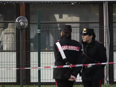 Italian Carabinieri patrol in front of a bar where three people died after a man entered and shot in Rome, Sunday, Dec. 11, 2022. (AP Photo/Gregorio Borgia)