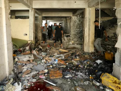 Palestinians inspect a school, which was sheltering displaced people, after it was hit by an Israeli strike, amid the Israel-Hamas conflict, in Gaza City, September 21, 2024. REUTERS/Dawoud Abu Alkas