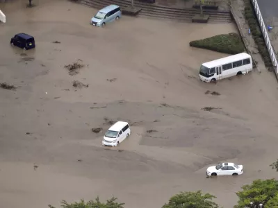 In this aerial photo, the car park of a municipal office is seen under water, after heavy rain in Wajima, Ishikawa prefecture, Saturday, Sept. 21, 2024. (Kyodo News via AP)