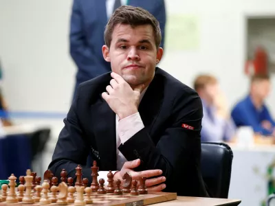 FILE PHOTO: Chess - 2018 World Rapid and Blitz Chess Championships - Rapid Open - Saint Petersburg, Russia - December 26, 2018. Magnus Carlsen of Norway plays against Adam Tukhaev of Ukraine. REUTERS/Anton Vaganov/File Photo