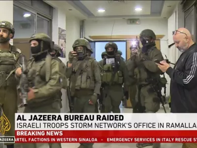 This image made from video provided by Al Jazeera English shows Israeli troops raiding their bureau in Ramallah, West Bank, Sunday, Sept. 22, 2024. (Al Jazeera via AP)