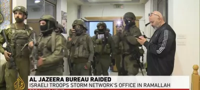 This image made from video provided by Al Jazeera English shows Israeli troops raiding their bureau in Ramallah, West Bank, Sunday, Sept. 22, 2024. (Al Jazeera via AP)