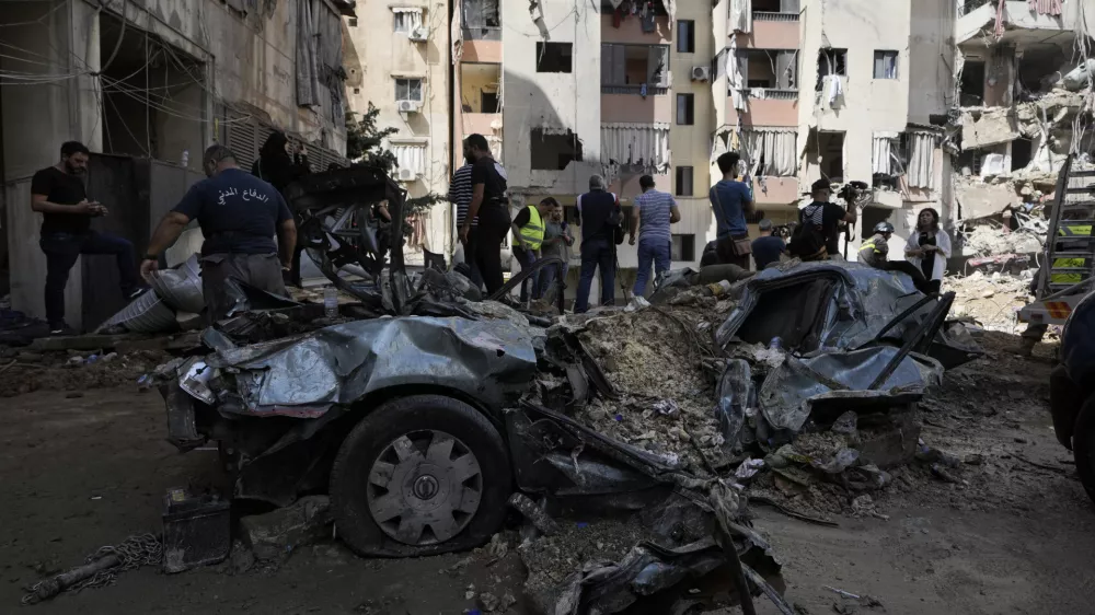 Emergency workers clear the rubble at the site of Friday's Israeli strike in Beirut's southern suburb, Sunday, Sept. 22, 2024. (AP Photo/Bilal Hussein)