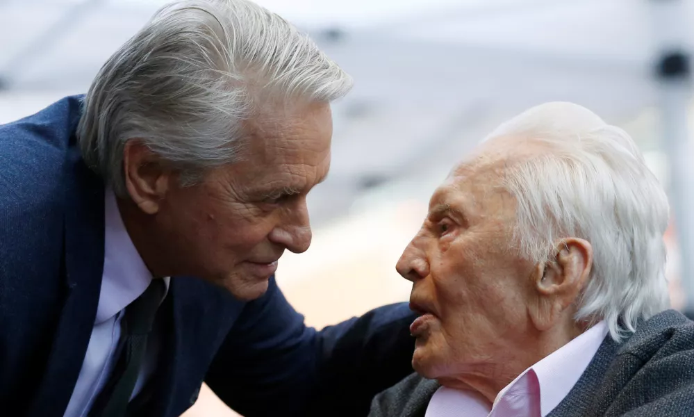 ﻿FILE PHOTO: Actor Kirk Douglas talks with his son actor Michael Douglas prior to the unveiling of Michael Douglas' star on the Hollywood Walk of Fame in Los Angeles, California, U.S., November 6, 2018. REUTERS/Mario Anzuoni/File Photo