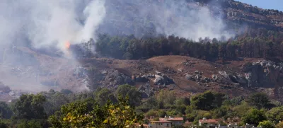 Smoke and flames are visible near homes in Kiryat Shmona after a rocket attack launched from Lebanon, amid cross-border hostilities between Hezbollah and Israel, in northern Israel, September 26, 2024. REUTERS/Jim Urquhart