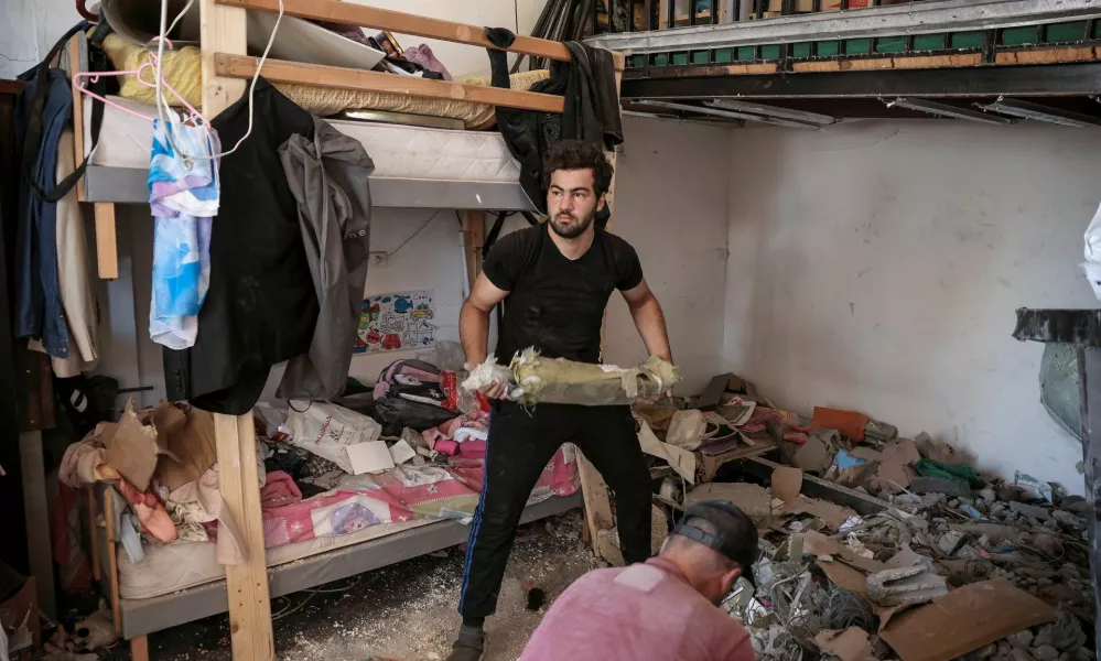 People clean debris from a damaged house amid ongoing search for survivors, a day after an Israeli strike on residential buildings in Maaysra, north of Beirut, Lebanon, September 26, 2024. REUTERS/Louisa Gouliamaki / Foto: Louisa Gouliamaki