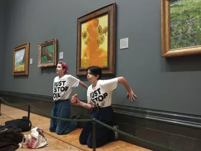 FILE - This photo provided by Just Stop Oil shows two protesters who have thrown tinned soup at Vincent Van Gogh's famous 1888 work Sunflowers at the National Gallery in London, Oct. 14, 2022. (Just Stop Oil via AP)