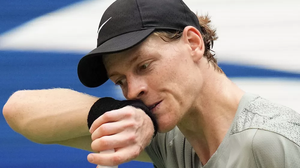 FILE - Jannik Sinner, of Italy, wipes sweat from his face between serves to Mackenzie McDonald, of the United States, during the first round of the U.S. Open tennis championships, Tuesday, Aug. 27, 2024, in New York. (AP Photo/Kirsty Wigglesworth, File)