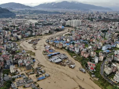 In this aerial image of the Kathmandu valley, Bagmati River is seen in flood due to heavy rains in Kathmandu, Nepal, Saturday, Sept. 28, 2024. (AP Photo/Gopen Rai)