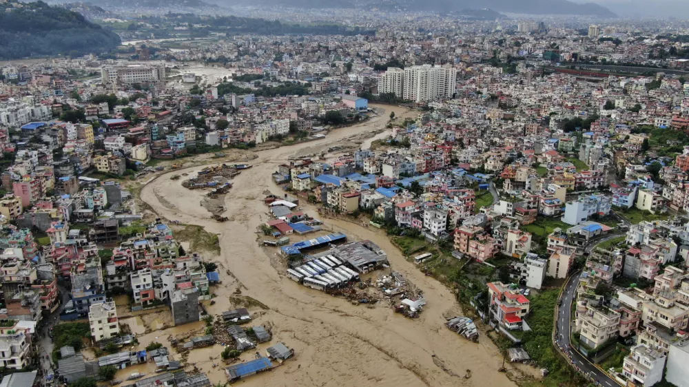 In this aerial image of the Kathmandu valley, Bagmati River is seen in flood due to heavy rains in Kathmandu, Nepal, Saturday, Sept. 28, 2024. (AP Photo/Gopen Rai)