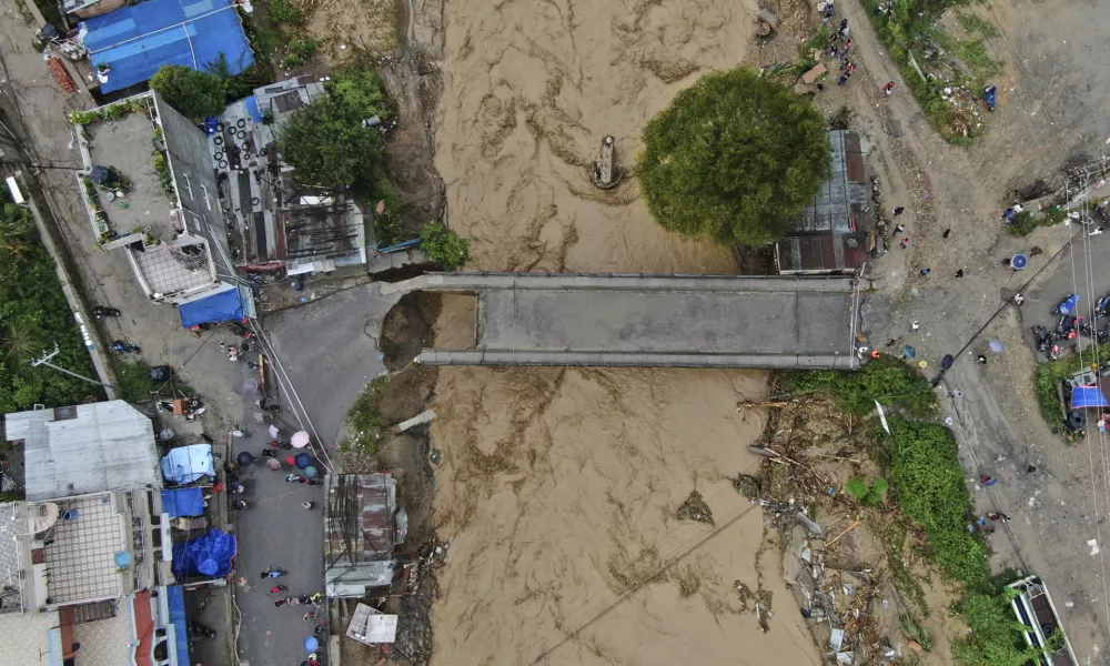 In this aerial image of the Kathmandu valley, Bagmati River is seen in flood due to heavy rains in Kathmandu, Nepal, Saturday, Sept. 28, 2024. (AP Photo/Gopen Rai)