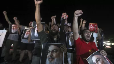 Lebanese and Palestinian men hold portraits of Hezbollah leader Sayyed Hassan Nasrallah, as they shout slogans during a protest in the southern port city of Sidon, Lebanon, Saturday, Sept. 28, 2024. (AP Photo/Hussein Malla)