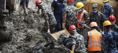 EDS NOTE: GRAPHIC CONTENT - Rescue personnel transport the dead body of a victim who was trapped under a landslide caused by heavy rains in Kathmandu, Nepal, Sunday, Sept. 29, 2024. (AP Photo/Sujan Gurung)