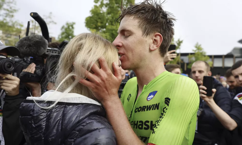 Slovenia's Tadej Pogacar kisses his girlfriend Urska Zigar after winning the Men Elite road race of the Cycling and Para-cycling Road World Championships in Zurich, Switzerland, Sunday, Sept. 29, 2024. (Michael Buholzer/Keystone via AP)