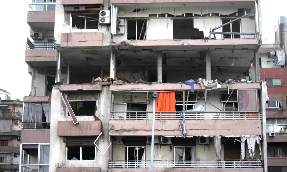 Damages are seen on a building that was hit by Israeli strike, early Monday, Sept. 30, 2024. (AP Photo/Hussein Malla)