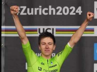 Slovenia's Tadej Pogacar cheers after winning the Men Elite road race of the Cycling and Para-cycling Road World Championships in Zurich, Switzerland, Sunday, Sept. 29, 2024. (AP Photo/Peter Dejong)