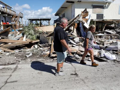 Tripp Gunti (L) and his sister Beth Harkala, residents of Keaton Beach work to recover their belongings from their family home after Hurricane Helene passed through the Florida panhandle, severely impacting the community in Keaton Beach, Florida, U.S., September 29, 2024. REUTERS/Octavio Jones