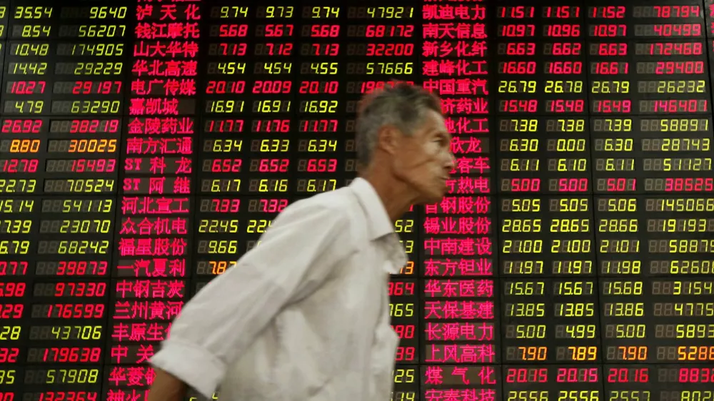 An investor walks past stock price monitor at a private securities company Thursday, Oct. 22, 2009 in Shanghai, China. China's economy expanded 8.9 percent in the third quarter, pumped up by easy credit and massive government spending that have ensured a recovery while the U.S., Japan and Europe continue to flounder. (AP Photo/Eugene Hoshiko)