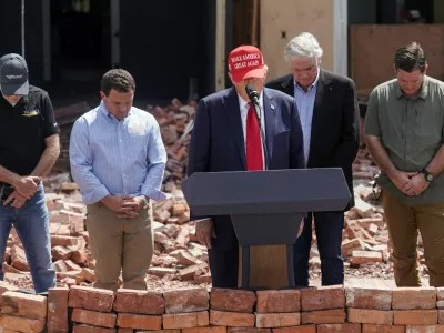 Republican presidential nominee and former U.S. President Donald Trump stands during a moment of silence at an event about the damage caused by Hurricane Helene, in Valdosta, Georgia, U.S., September 30, 2024. REUTERS/Elijah Nouvelage   TPX IMAGES OF THE DAY