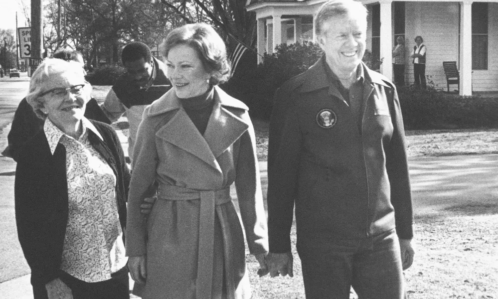 FILE - Former President Jimmy Carter, right, wife Rosalynn, center, and mother-in-law Allie Smith walk through Plains, Ga., Jan. 23, 1981, back home from their office. Well-wishes and fond remembrances for the former president continued to roll in Sunday, Feb. 19, 2023, a day after he entered hospice care at his home in Georgia. (AP Photo/Wayne Perkins, File)