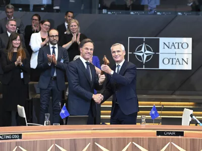 The outgoing NATO Secretary General Jens Stoltenberg, right, welcomes the new NATO Secretary General Mark Rutte during a handover ceremony at NATO headquarters in Brussels, Belgium, Tuesday, Oct. 1, 2024. (AP Photo/Harry Nakos)