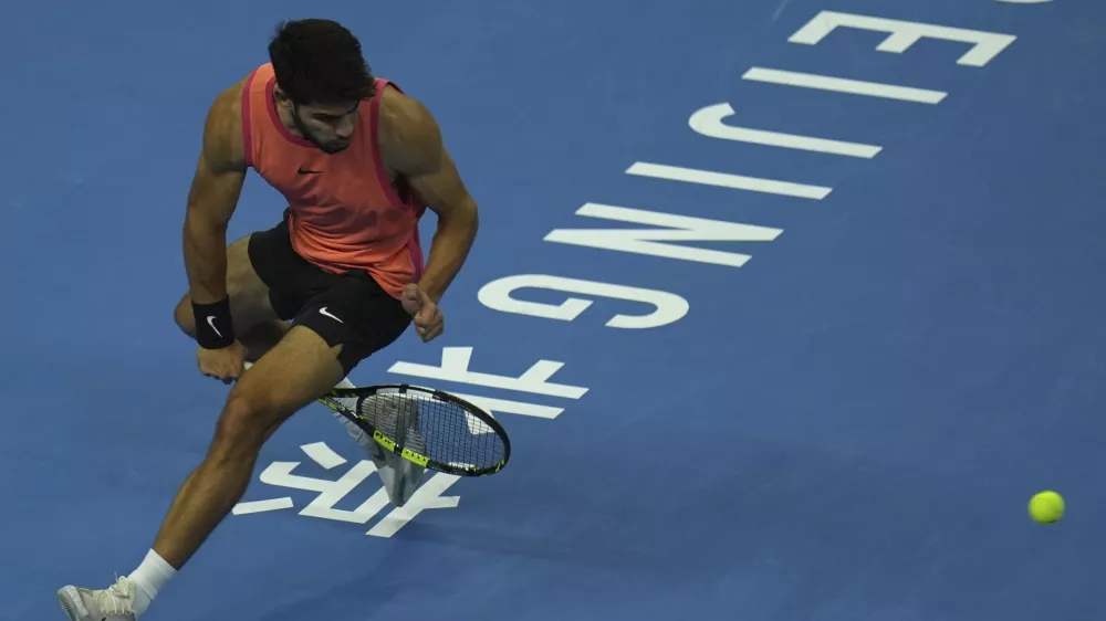 Carlos Alcaraz of Spain returns a shot from Daniil Medvedev of Russia during their men's singles semi-final match for the China Open tennis tournament held at the National Tennis Center in Beijing, Tuesday, Oct. 1, 2024. (AP Photo/Ng Han Guan)