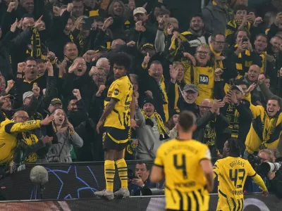 Dortmund's Karim Adeyemi celebrates with the fans his side's second goal during the Champions League opening phase soccer match between Borussia Dortmund and Celtic FC at the BVB Stadion in Dortmund, Germany, Tuesday, Oct. 1, 2024. (AP Photo/Martin Meissner)