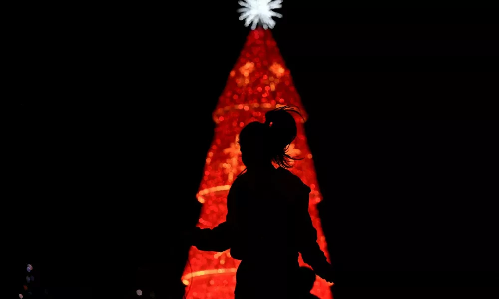 A woman jumps ropes in front of a Christmas tree, as the Christmas season kicks off as per a decree of Venezuela's President Nicolas Maduro, in Caracas, Venezuela October 1, 2024. REUTERS/Gaby Oraa   TPX IMAGES OF THE DAY