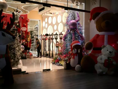 A woman cleans a store with Christmas decorations, as the Christmas season kicks off as per a decree of Venezuela's President Nicolas Maduro, in Caracas, Venezuela October 1, 2024. REUTERS/Gaby Oraa