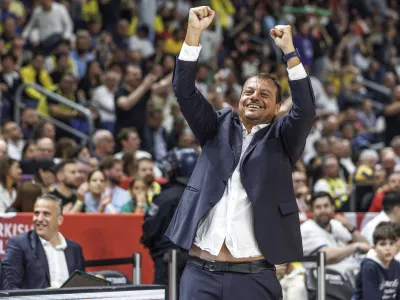 Panathinaikos Athens head coach Ergin Ataman cheers after the victory in the final round of the basketball Euroleague semifinal between Panathinaikos Athens and Fenerbahce Istanbul, at the Uber Arena in Berlin, Friday May 24, 2024. (Andreas Gora/dpa via AP)